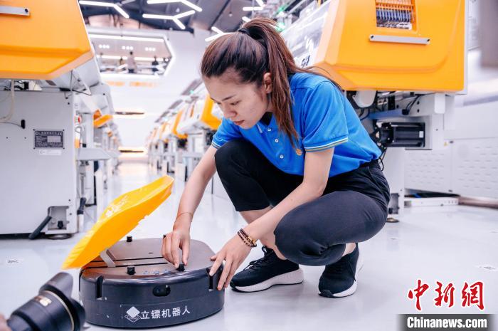 圖為員工在調(diào)試AGV搬運機器人。　李南軒 攝